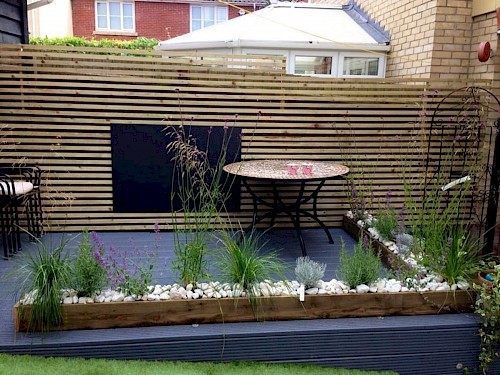 maintenance-free-garden-for-child-minder--with-artificial-lawn--black-board-for-kids-and-canopy-sail-and-raised-sensory-plan