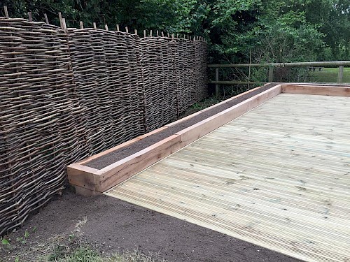Decking with raised beds and Hazel hurdle fencing