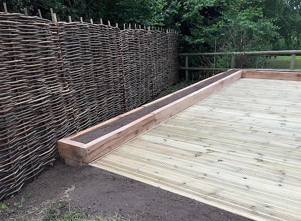 Decking with raised beds and Hazel hurdle fencing Decking with raised beds and Hazel hurdle fencing