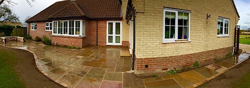 Sandstone paving with Log Seating area