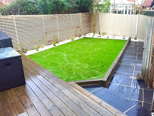 Artificial Lawn with batten fencing and limestone paving
