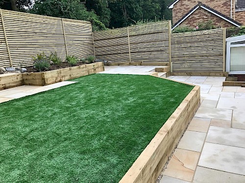Landscaping with sawn paving and artificial turf